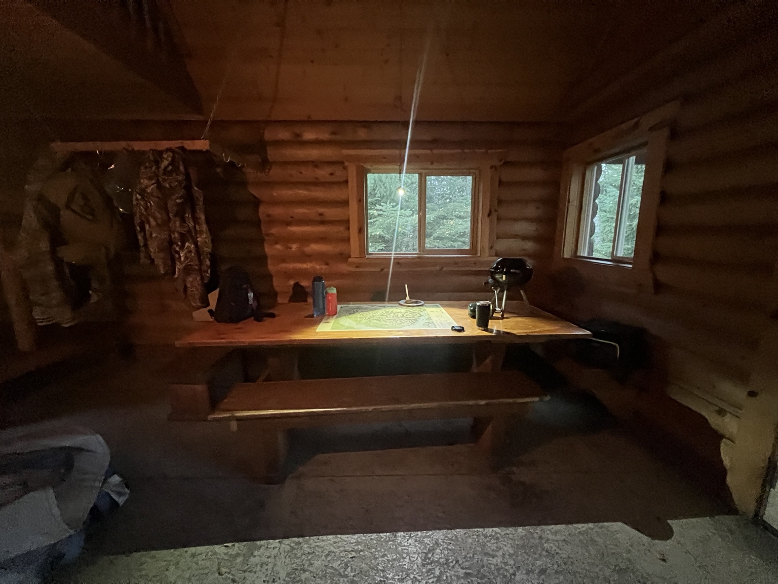 Long wooden table with benches inside Bore Tide Cabin