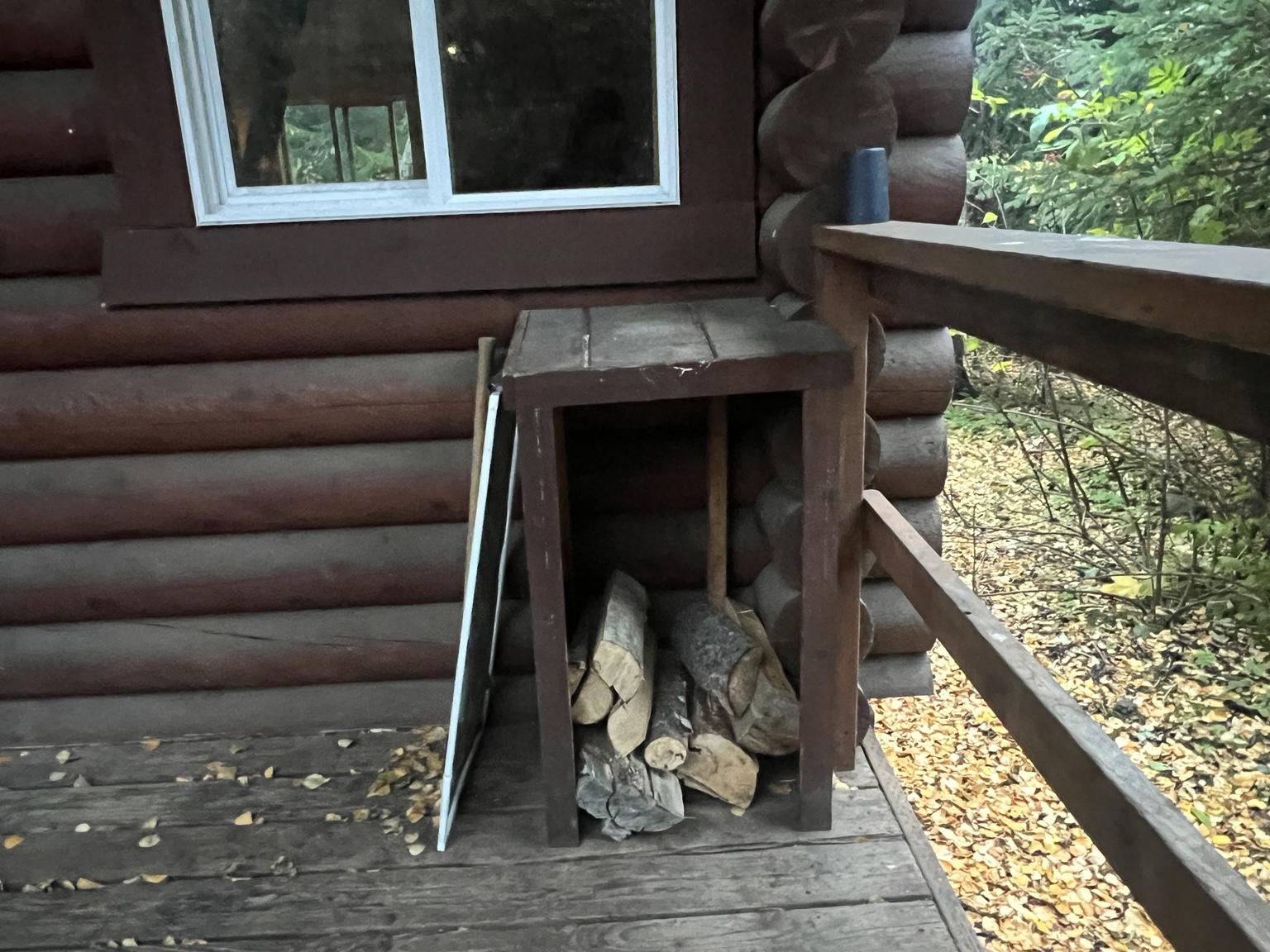 Small pile of firewood stored under the cabin porch