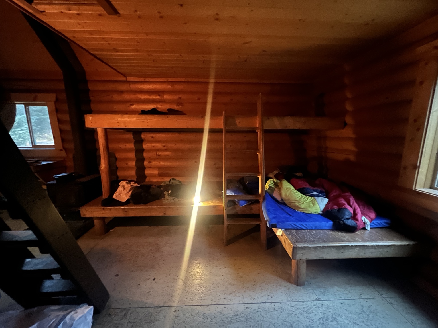 Wooden sleeping platforms and ladder in Bore Tide Cabin